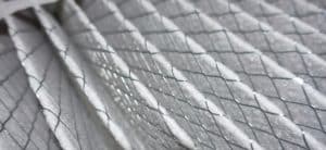 Close-up view of an air filter with pleated white material and a diamond-shaped wire mesh for support, highlighting the texture and pattern of the filter surface—ideal for understanding air filter maintenance needs. | High 5 Plumbing, Heating & Cooling